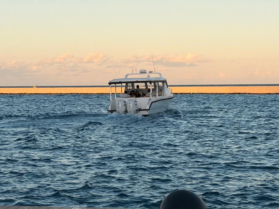 Small passenger boat travelling across open water.